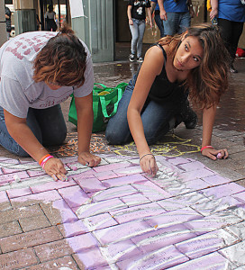 McCollum High School sophomore Lyric Garcia and junior Alexandra Martinez add the finishing touches to a skeletal horse mural at Chalk It Up on Saturday. Students from McCollum drew the horse to honor Dia de los Muertos. The event invited several local schools, organizations and featured artists to create large murals Downtown along Houston Street. Photo by Andrew Martinez