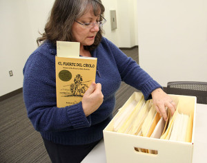 Librarian Stefanie Wittenbach holds “El Fuerte del Cíbolo”, one of the books donated by Robert H. Thornoff, while fipping through the original notes of the author for the making of the book. Photo by Monica Lamadrid