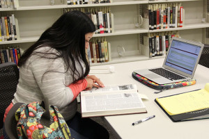 History senior Amanda Perez reads “Atascosa County Texas History” for her methods of historical research class, HIST 4301. Students can check out special collections books but can only use it in the reading room under supervision. Photo by Monica Lamadrid