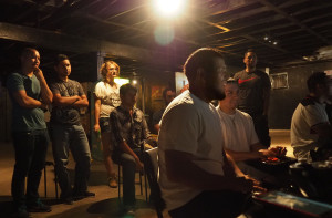 Members of San Antonio's fighting game community look on as two players fight one another in Tekken Tag Tournament 2. Photo by Evelyn Vallejo