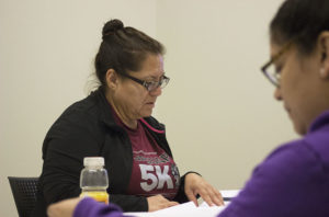 Cristina Frias, senior Psychology major, reviews the workbook provided to attendees of the Student Leadership Challenge on Saturday, October 22, 2016.