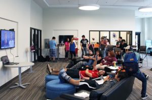 Students gathered around the student lounge and enjoyed complimentary pizza as they watched the debate.