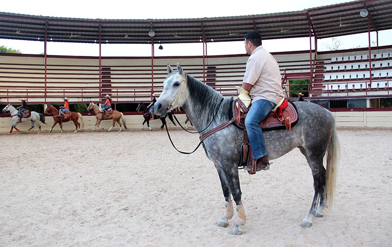 The escaramuza team, directed by Jimmy Ayala, practices rounds to discipline each horse on speed and obedience. Photo by Kimberly Rivera