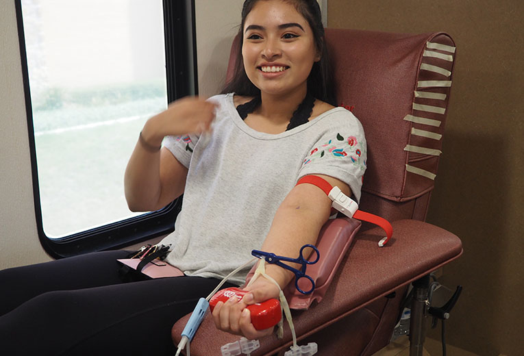 Ruby Silva, freshman business major at Texas A&M University-San Antonio, donates blood for Harvey relief. Photo by James Miller 