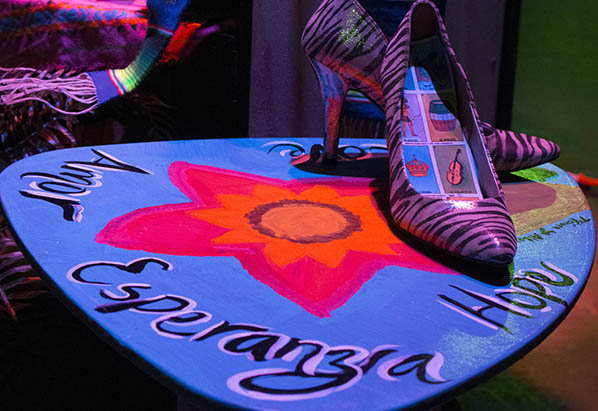 Zebra print high heels with loteria cards in the soles from the monologue Cha-Cha to Panza in The Panza Monologue .