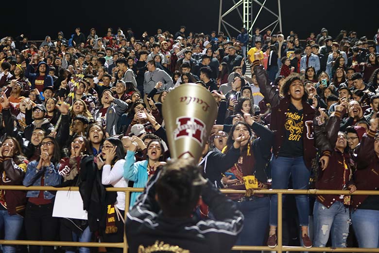 The Harlandale student section erupts in pandemonium after Edward Beltran caught a last-minute touchdown. The Indians won the 54th Frontier Bowl, 24-21. Photo by Jose Arredondo.