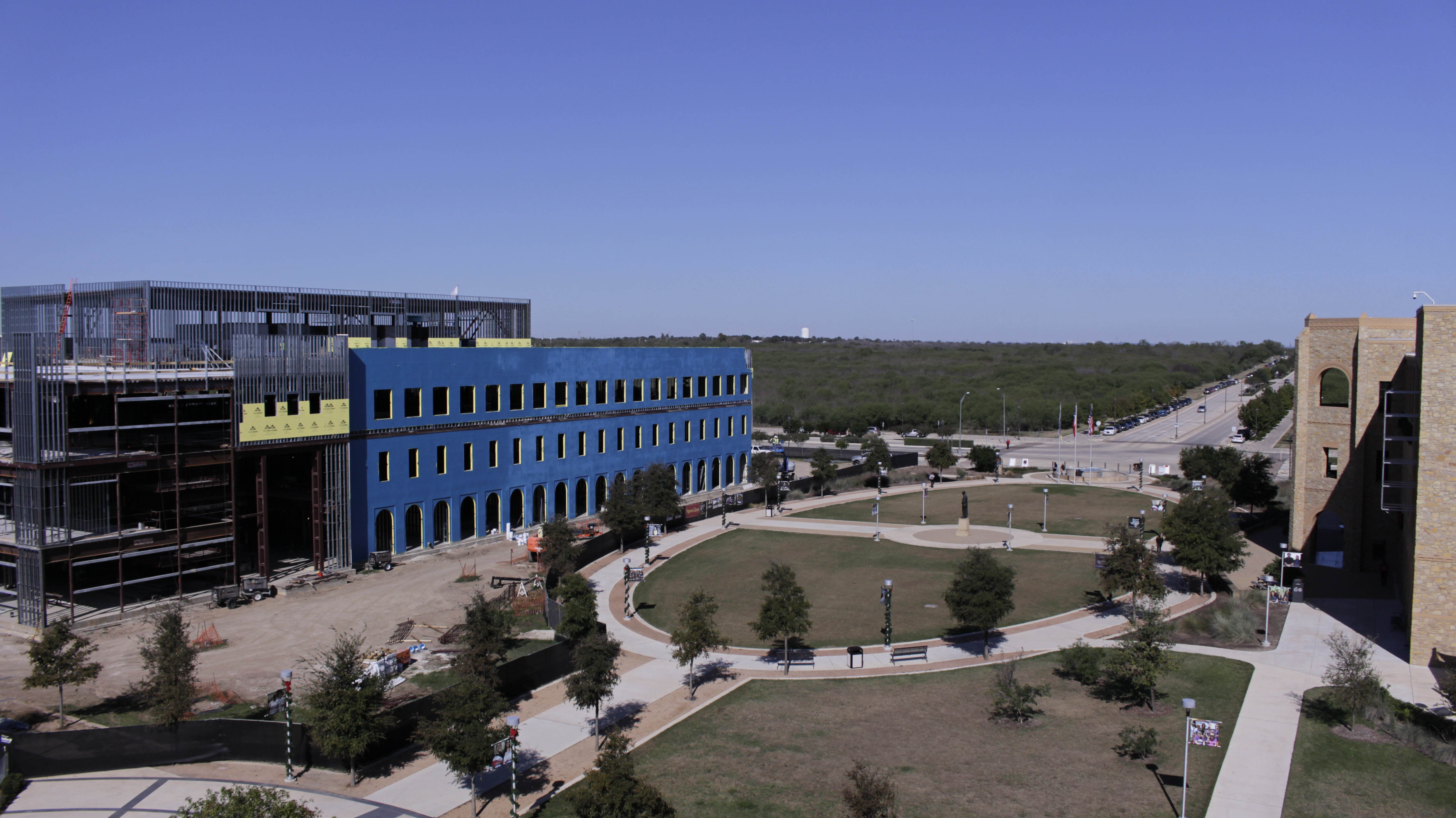 High angle view of the development of the science and technology building being overlooked by the late Senator, Frank Madla statue. Campus of Texas A&M University of San Antonio.
