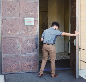 Cyber security freshman Christopher Deleon struggles to open the broken door of the Central Academic Building at Texas A&M University-San Antonio on Oct. 22, 2019. Photo by Jessica Lann 