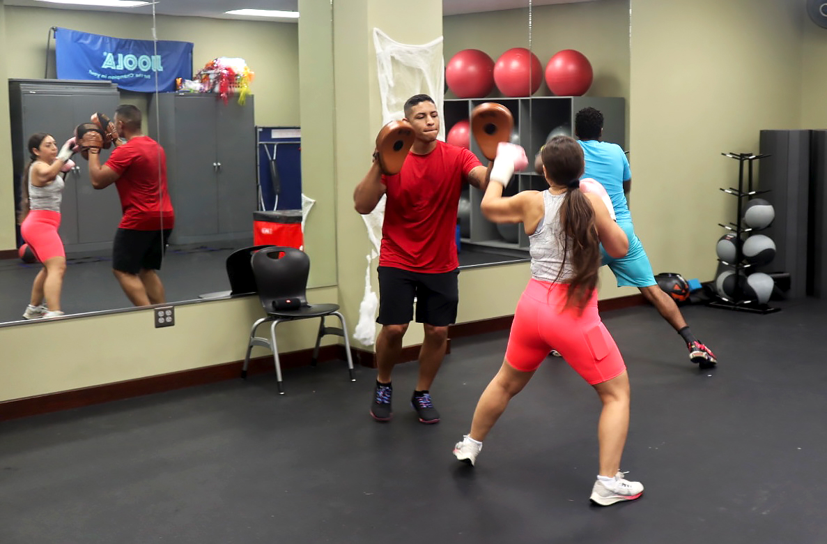 Group fitness class combines boxing and weight training workouts for